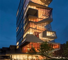 A tall tower is lit up against the night sky